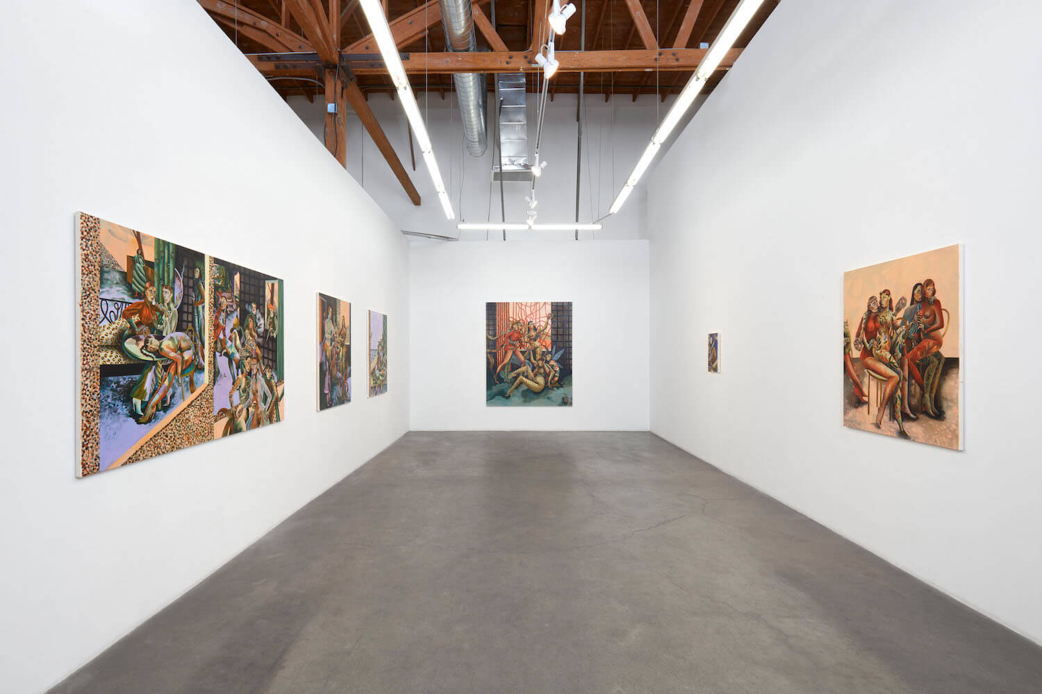 an installation view of jessie makinson's paintings on white walls with concrete floors